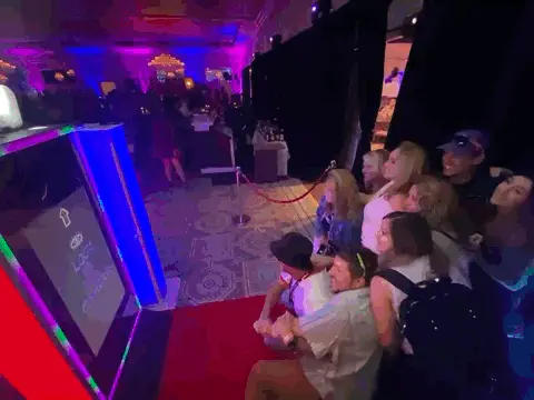 guests posing in front of photo booth mirror booth co